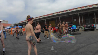 6. Bubbles Bikes and Breasts. Artist nude woman popping giant bubbles at the LA world naked bike ride.