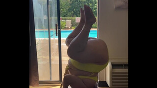 2. BBW plus-size doing head stand in bathing suit