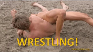 Wrestling clothing-free at a beach festival