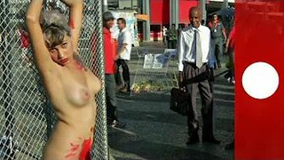 Chained naked to a fence, woman protests against sexism in Brazil