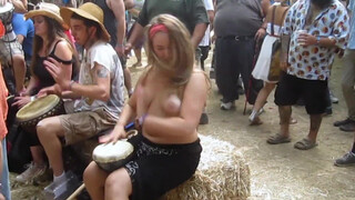 1. Beating the Bongo and Bouncy Breasts. Drum circle with topless hippy drummer free spirit.