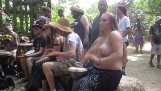 5. Beating the Bongo and Bouncy Breasts. Drum circle with topless hippy drummer free spirit.