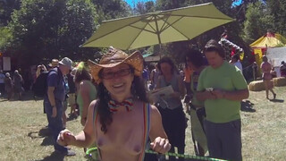 6. Topless Cowgirl Hippy with Lime Green Hula Hoop and Rave Skirt Enjoying the Sunny Day at a Festival