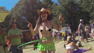 Topless Cowgirl Hippy with Lime Green Hula Hoop and Rave Skirt Enjoying the Sunny Day at a Festival