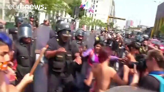 2. Topless protesters clash with police in Peru